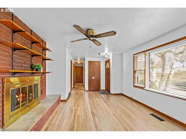 a living room with stainless steel appliances furniture and a large window