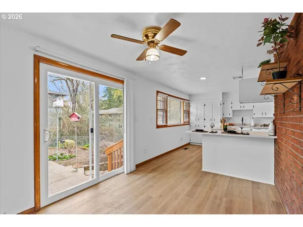 a kitchen with stainless steel appliances kitchen island granite countertop a sink a stove a microwave a counter space and cabinets