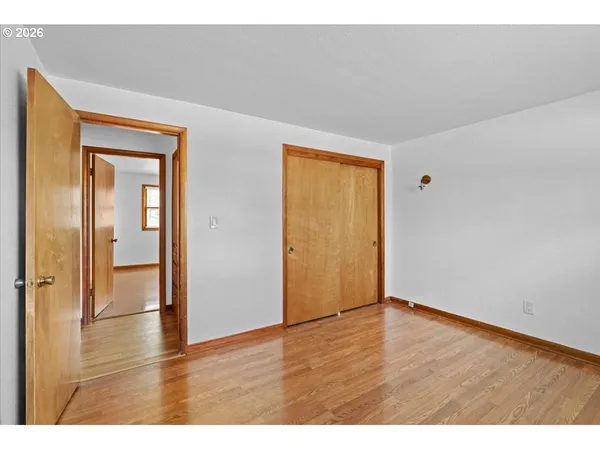 a view of an empty room and wooden floor