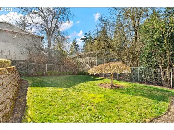 a view of yard with swimming pool and green space