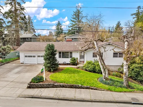 an aerial view of a house with a garden and a car parked