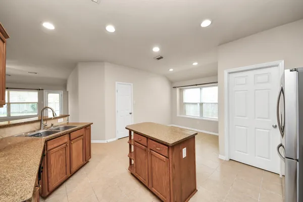a kitchen with stainless steel appliances granite countertop a sink and a stove