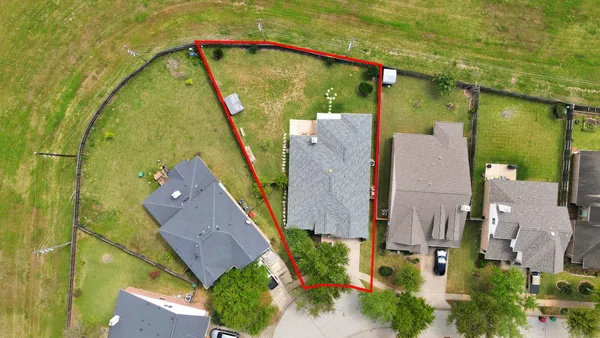 a front view of house with backyard and green space