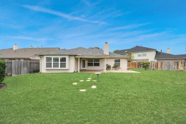 a view of a house with a yard and sitting area