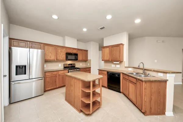 a kitchen with a sink stainless steel appliances and cabinets