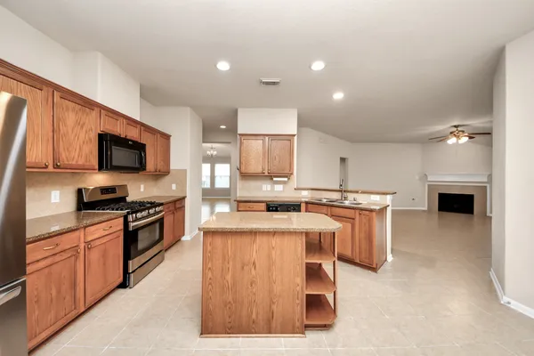 a kitchen with cabinets and a counter top space