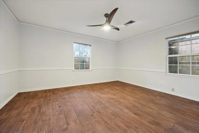wooden floor in an empty room with a window