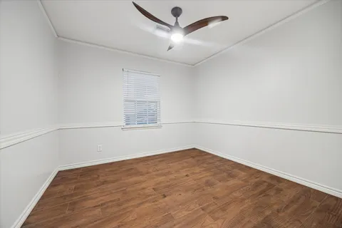 an empty room with a empty space and a ceiling fan