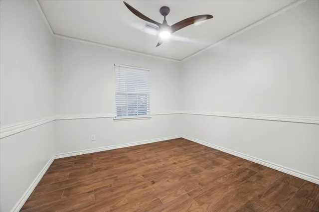 an empty room with a empty space and a ceiling fan
