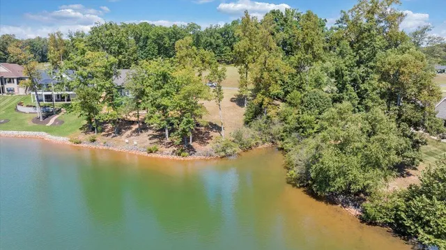 an aerial view of a house with a lake view