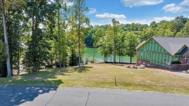 a view of a house with basketball court and a yard