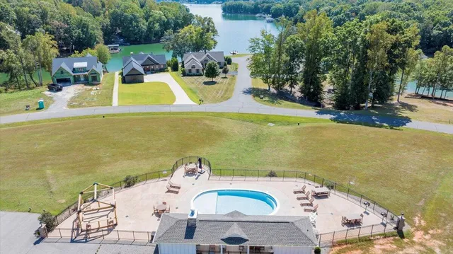 a view of a lake with a yard and outdoor seating