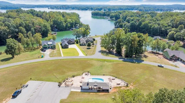 a view of a house with backyard and pool