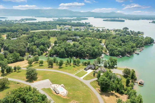an aerial view of a house with a yard and lake view