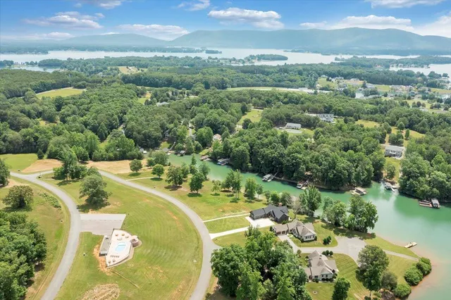 an aerial view of a house with a yard and lake view
