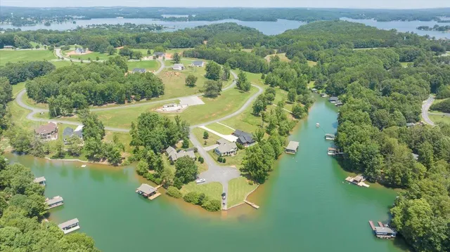 an aerial view of a house with outdoor space and a lake view