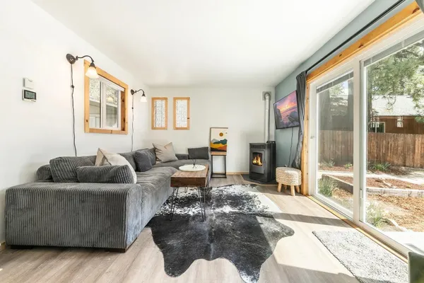 a living room with furniture and a floor to ceiling window