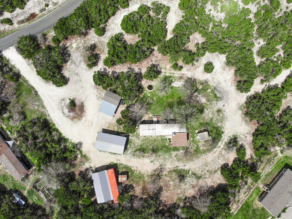 an aerial view of house with yard and swimming pool