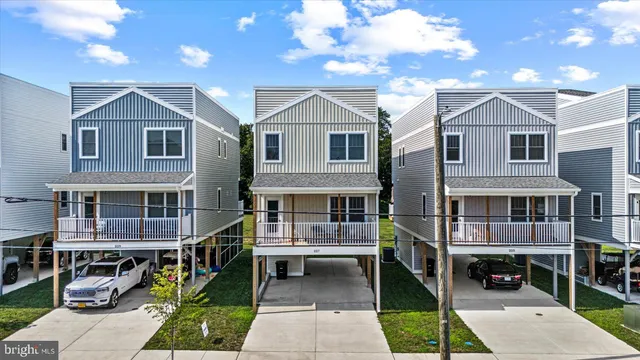 a view of house with a small yard and sitting area