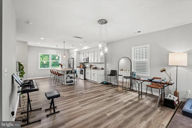 a living room with furniture and wooden floor