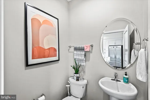 a bathroom with a toilet a sink and a mirror