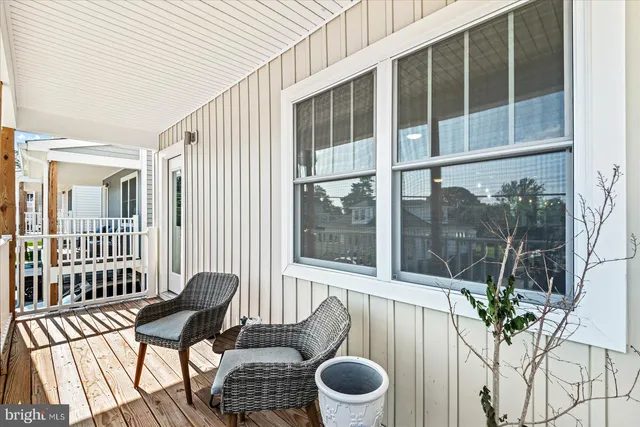 a view of a balcony with chair and potted plant