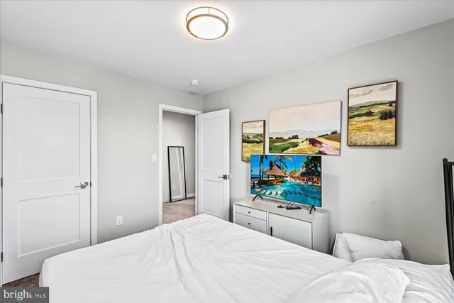 a bedroom with a bed and a flat screen tv