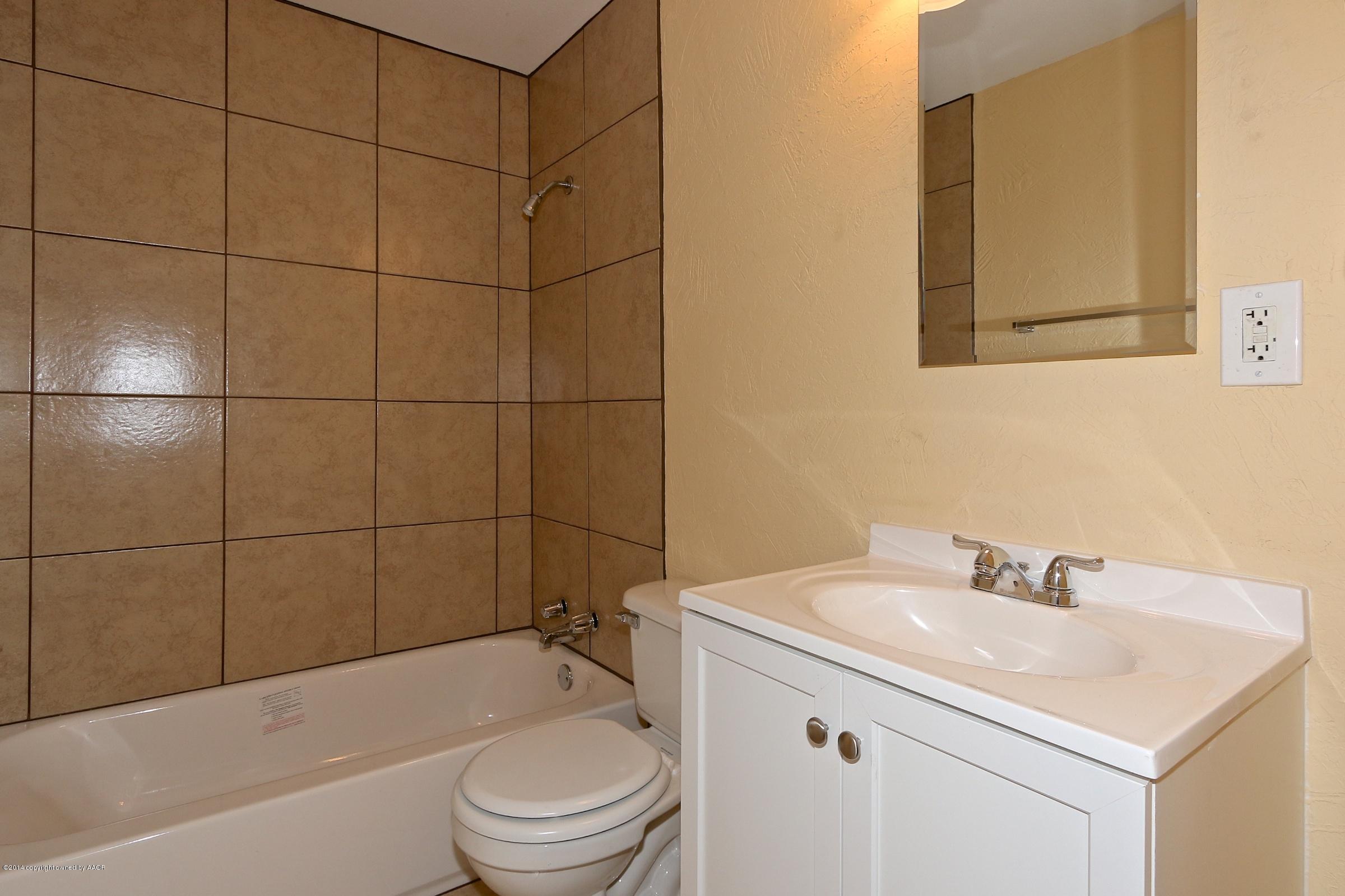 4205 South Tyler Street Amarillo, TX 79110 - Photo 3 of 19 a bathroom with a sink a toilet and shower