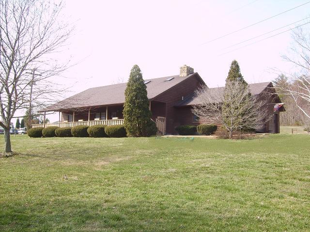 9820 Roanoke Road Elliston, VA 24087 - Photo 1 of 23 a front view of house with yard and trees all around