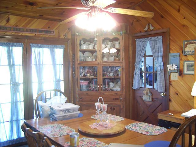 9820 Roanoke Road Elliston, VA 24087 - Photo 15 of 23 a dining room with wooden floor a chandelier a wooden table and chairs