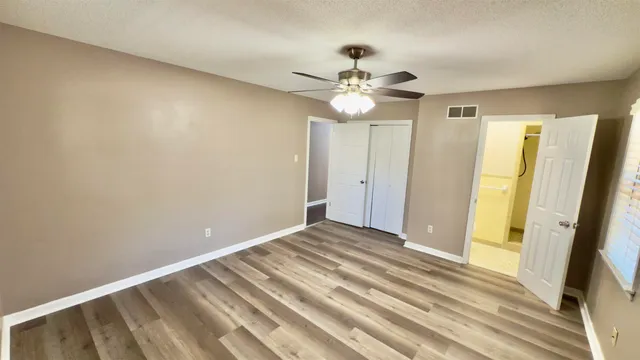 a view of an empty room with a bathroom