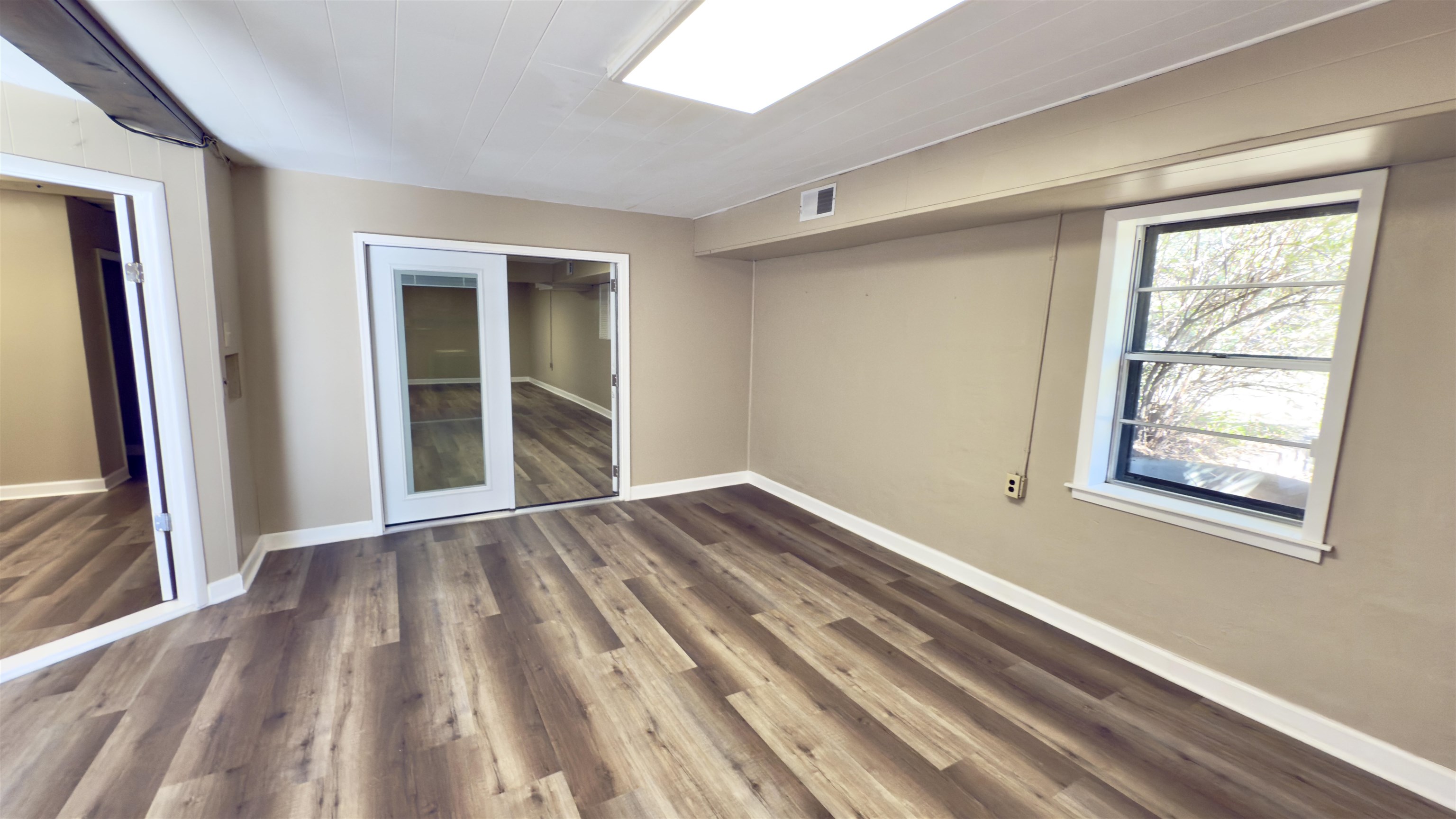 2563 Hacks Cross Road Germantown, TN 38138 - Photo 20 of 28 a view of an empty room with wooden floor and a window