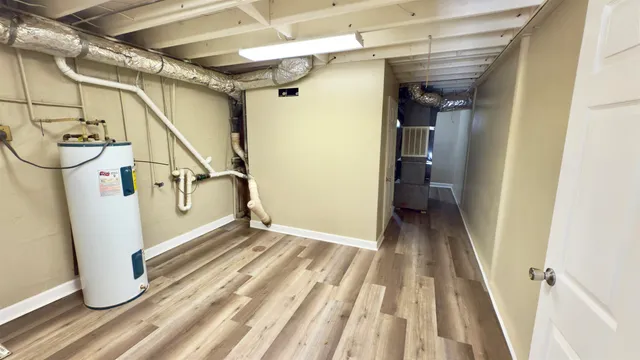 a view of a room with wooden floor