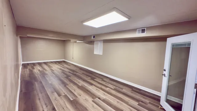 a view of a room with wooden floor