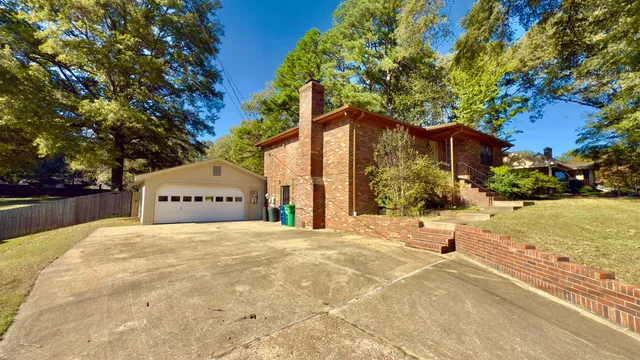 a large house with a large tree in front of it