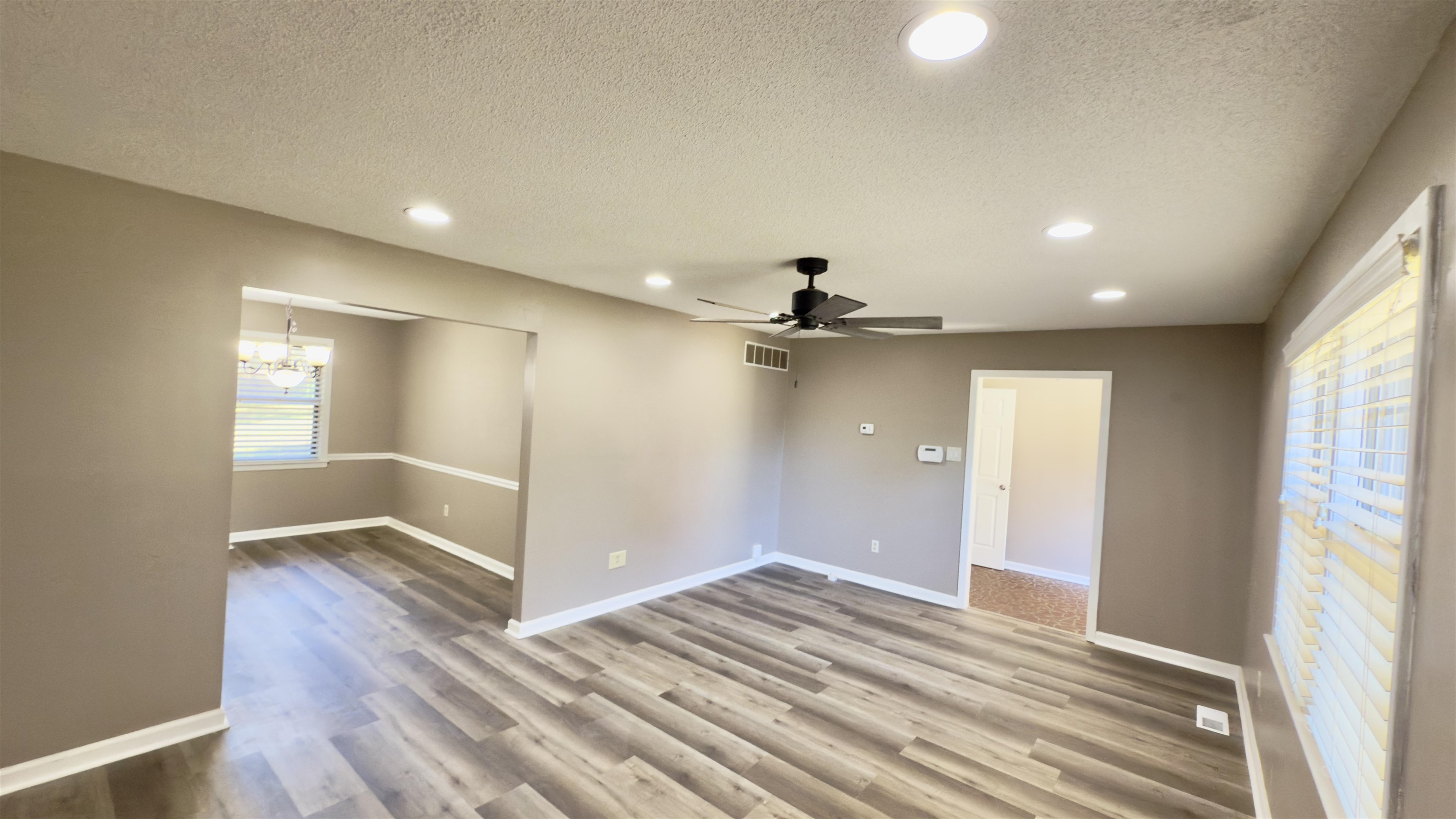 2563 Hacks Cross Road Germantown, TN 38138 - Photo 6 of 28 a view of an empty room and window and wooden floor