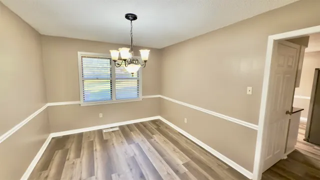 a view of a room with window wooden floor and staircase