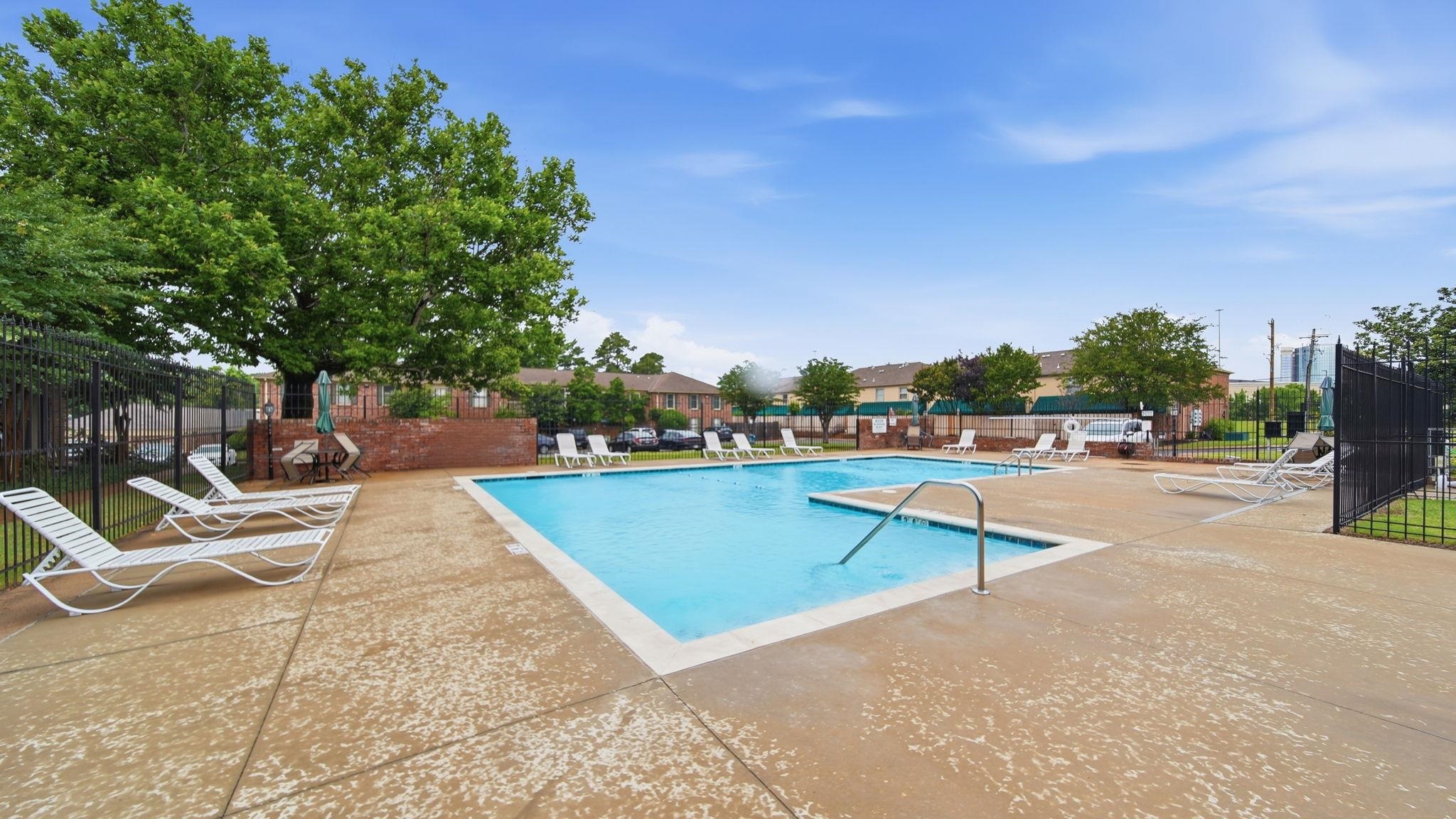 5866 Roxbury Drive, Unit 5866 Memphis, TN 38119 - Photo 18 of 20 Expansive swimming pool with integrated spa and surrounding concrete patio