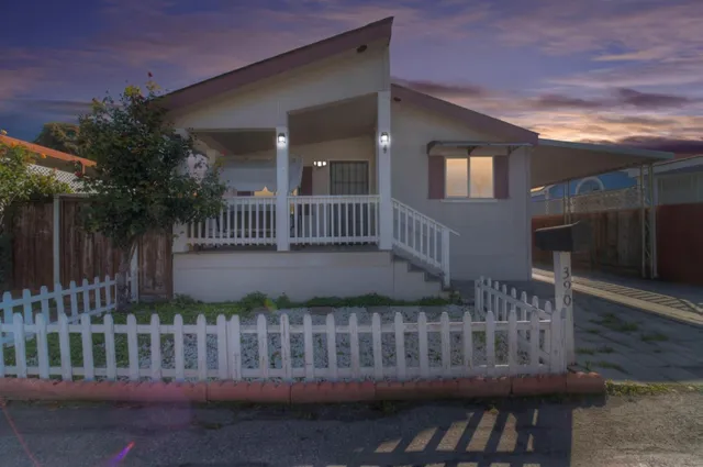 a view of a house with a wooden deck