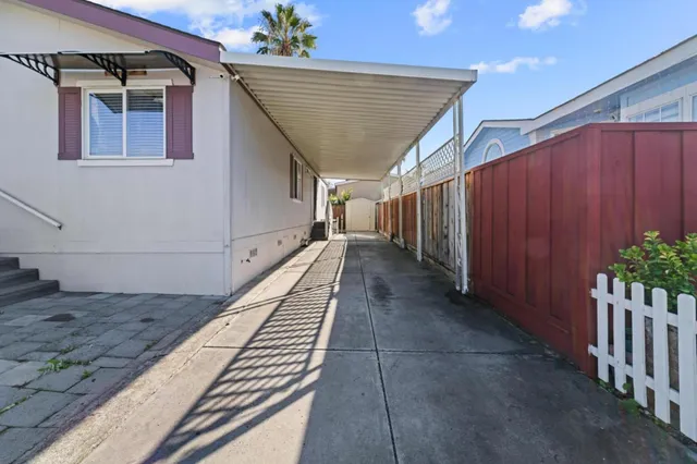 a living room with stainless steel appliances furniture kitchen view and a flat screen tv