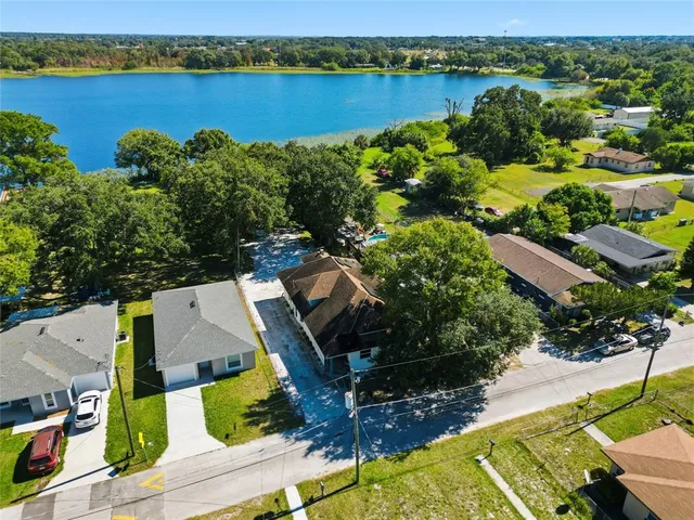 an aerial view of a houses with a lake view