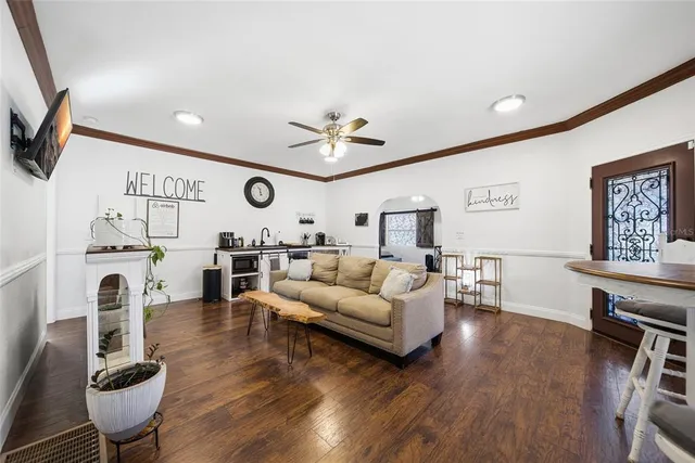 a living room with furniture a fireplace and a flat screen tv