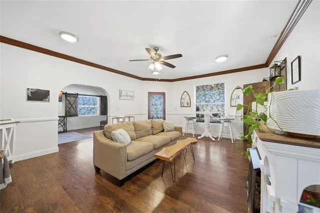 a living room with furniture and wooden floor