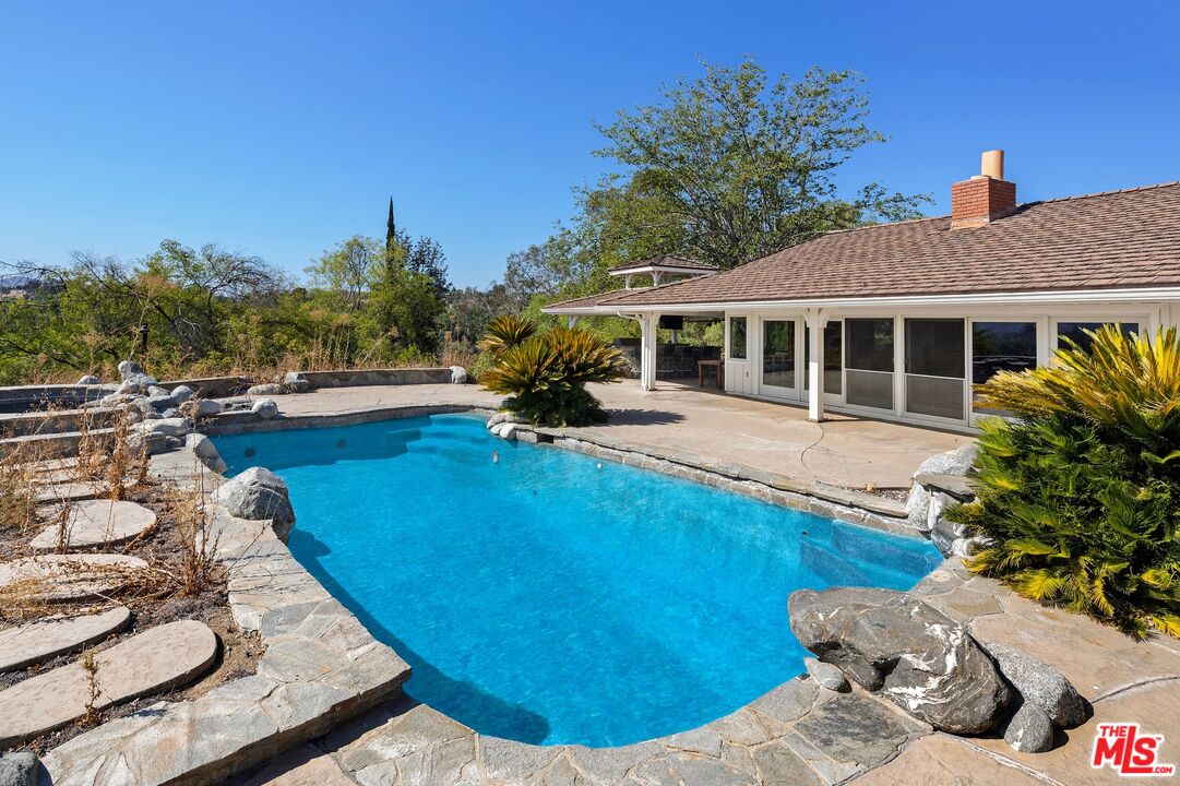 24930 Eldorado Meadow Road Hidden Hills, CA 91302 - Photo 6 of 10 a view of a house with swimming pool and sitting area