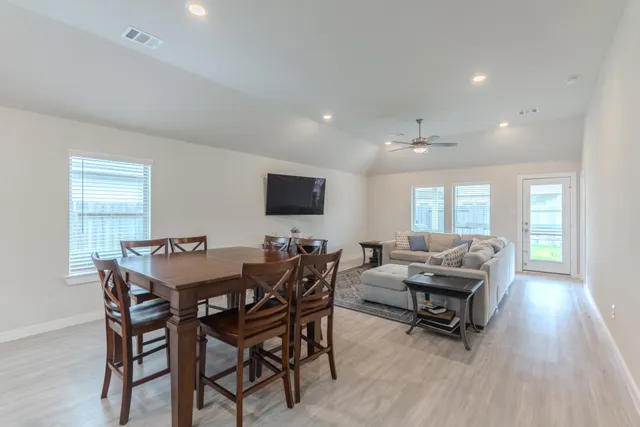 a view of a dining room with furniture and wooden floor
