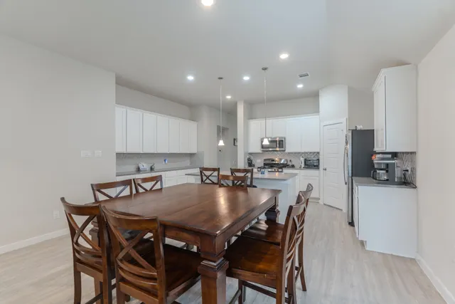 a kitchen with a table and chairs in it