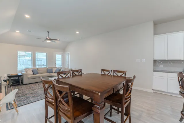a view of a dining room with furniture and wooden floor