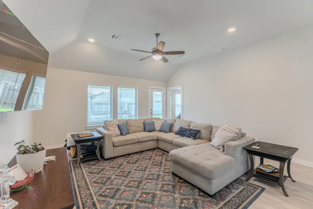 a living room with furniture and a chandelier