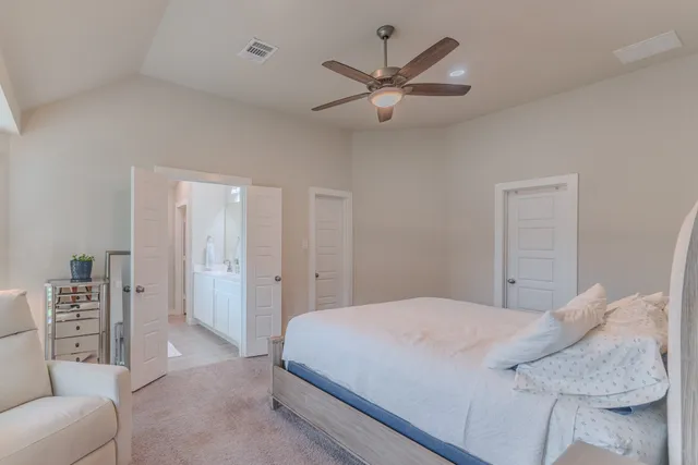 a bedroom with a large bed and a couch