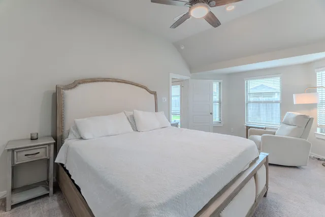 a bedroom with a large bed and a chandelier